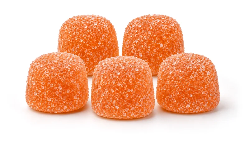 Five orange sugar-coated gummies