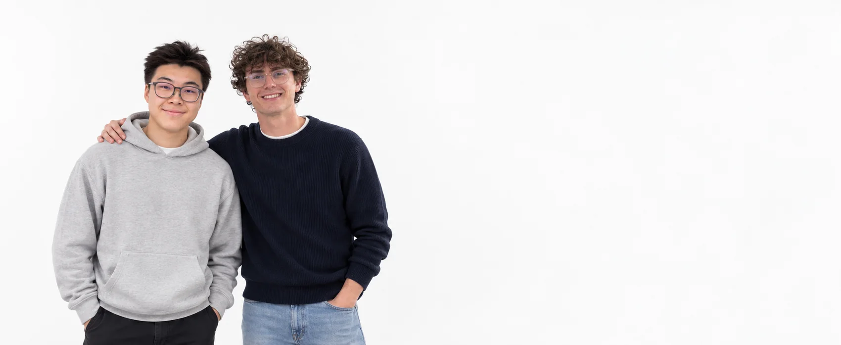 Forrest and Sam, co-founders of Stage 2, in a white studio. Forrest is on the left; Sam has his arm around him.